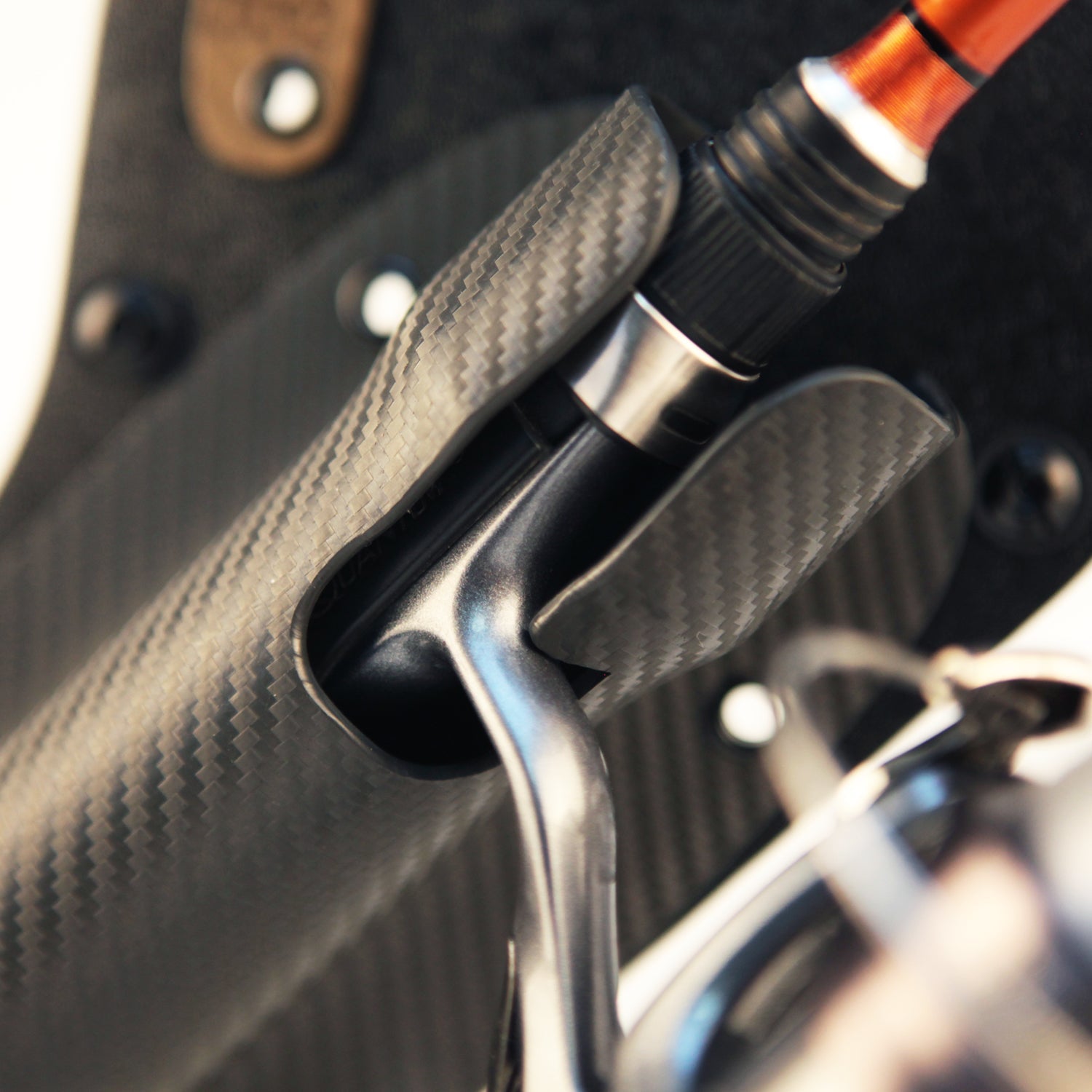 Close-up of Pine 9 fishing rod holster mounted on belt supporting spinning rod and reel