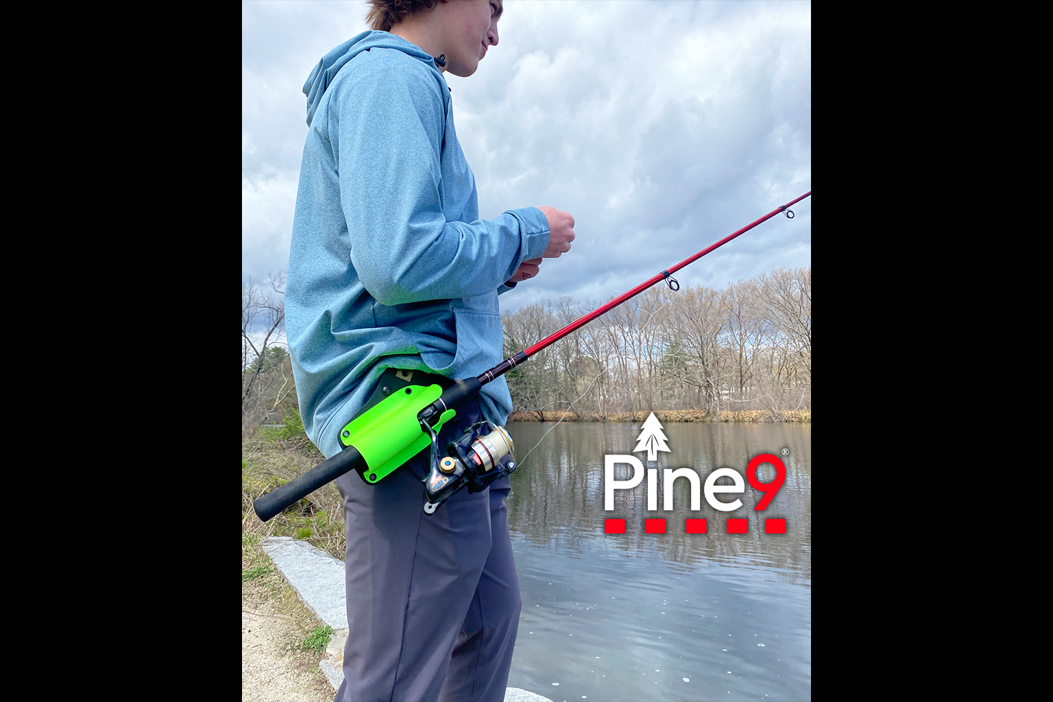 pine 9 JettyHawk fishing rod holster hands free hip rod hip holder man wearing a zombie green fishing rod holster fishing next to a river