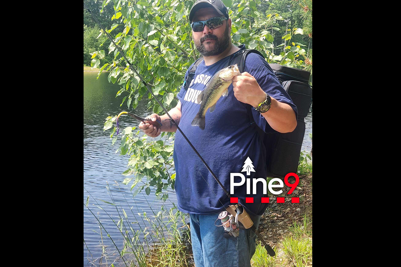pine 9 JettyHawk fishing rod holster hands free hip rod hip holder man holding fish and fliers in the other