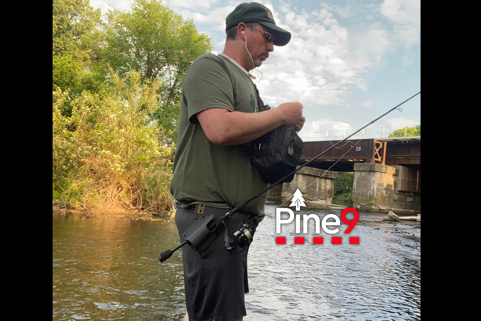 pine 9 JettyHawk fishing rod holster hands free hip rod hip holder man standing in water with his rod in hip belt holder.
